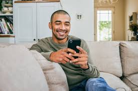 man scheduling vasectomy appointment on phone